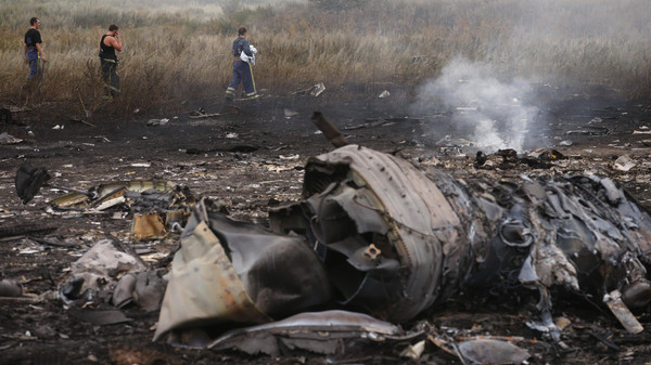 Emergencies Ministry members walk at the site of a Malaysia Airlines Boeing 777 plane crash near the settlement of Grabovo in the Donetsk region