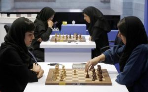 Iranian chess players Mitra Hejazipour (L) and Sara Khademalsharieh play at the Chess Federation in the capital Tehran on October 10, 2016. For the Iranian players the veil is not a sign of oppression, they oppose a campaign launched in the United States against the holding of the Women's World Championship in February in Tehran Credit: AFP/Getty Images