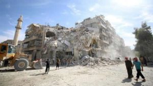 People inspect a damaged site after an air strike Sunday in the rebel-held besieged al-Qaterji neighbourhood of Aleppo, Syria October 17, 2016.