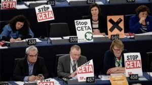 Member of European Parliament take part in a voting session, next to placards reading Stop CETA, at the European Parliament in Strasbourg, eastern France, on October 26, 2016