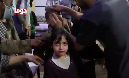 A girl looks on following chemical weapons attack in Douma